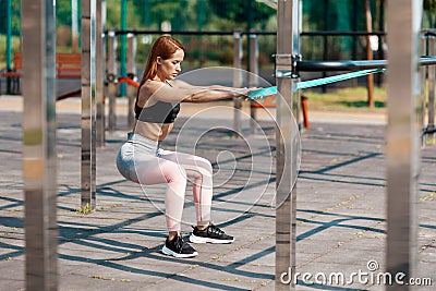 Athletic adult woman doing deadlifts on the sport ground. Strength and endurance Stock Photo