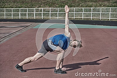 Athletic bearded man with muscular body doing exercises Stock Photo