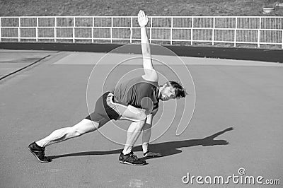 Athletic bearded man with muscular body doing exercises Stock Photo