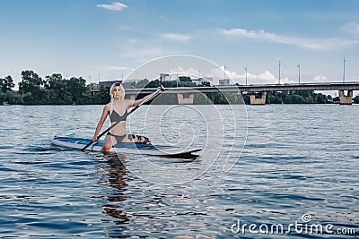 athletic beautiful girl paddle boarding Stock Photo