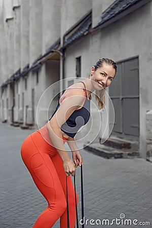 Athletic beautiful woman during fitness class in old european city Stock Photo