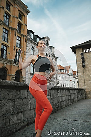 Athletic beautiful woman during fitness class in old european city Stock Photo