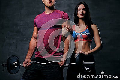 The athletic, blond male holds barbell weight and slim fitness f Stock Photo