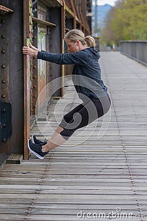 Athletic blond woman doing stretching exercises Stock Photo