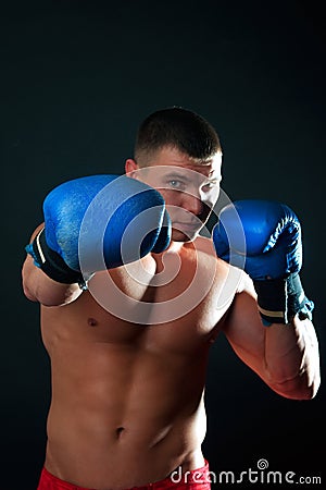 Athletic boxer during fighting Stock Photo