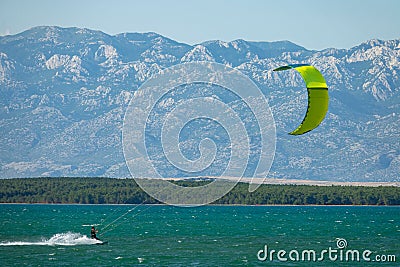 Athletic Caucasian male is kitesurfing in the scenic Adriatic seaside in Croatia Stock Photo