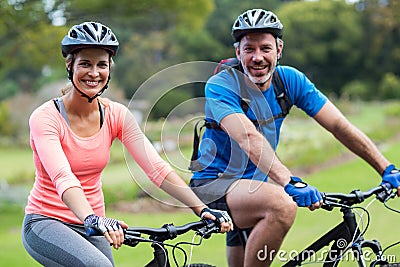 Athletic couple cycling on the road Stock Photo