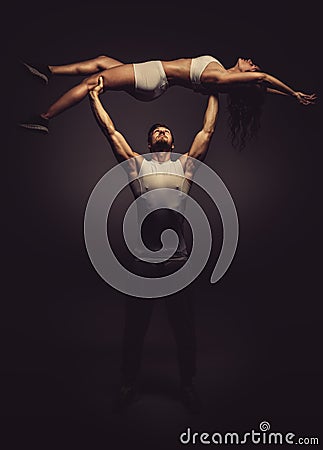 Athletic couple doing acro yoga Stock Photo