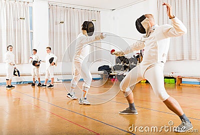 Athletic group practicing fencing techniques Stock Photo