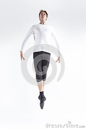 Professional Caucasian Handsome Young Man Posing in Moving Ballet Pose with Circled Hands in White Shirt On White Stock Photo