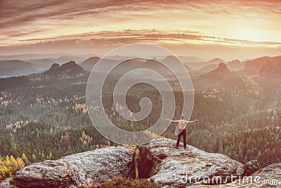 Athletic man with muscular body on cliff Stock Photo