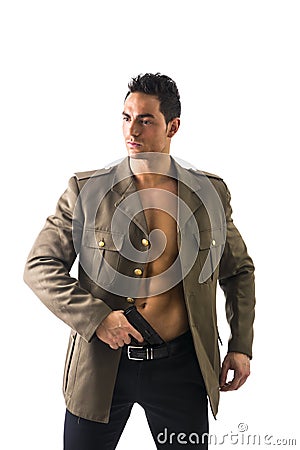 Athletic Man in Open Military Jacket Holding Gun Stock Photo