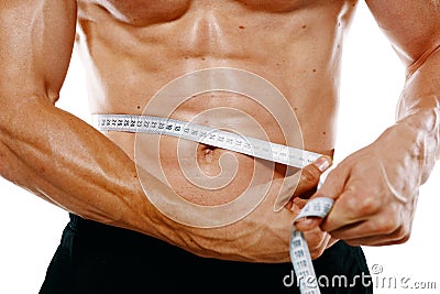 athletic man with pumped up muscular body measures with tape Stock Photo