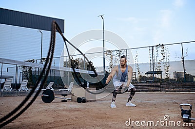 Athletic man with ropes, street workout, crossfit Stock Photo