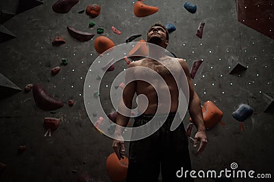 Athletic man using chalk before climbing in a bouldering gym Stock Photo