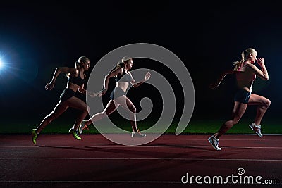 Athletic runners passing baton in relay race Stock Photo