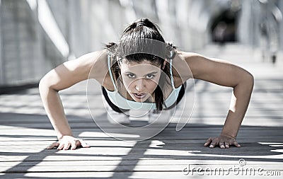 Athletic sport woman doing push up before running in urban training workout Stock Photo