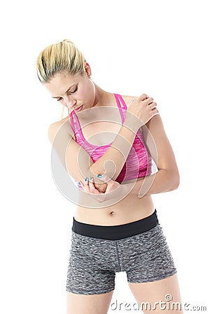 Athletic woman clutching elbow and shoulder Stock Photo