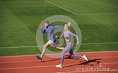 athletic woman and man of sprinters run on running track at stadium, endurance Stock Photo