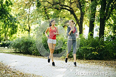 Athletic women jogging in nature Stock Photo