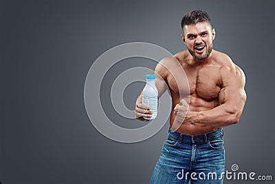 Athletic young handsome man with white shake bottle. Stock Photo