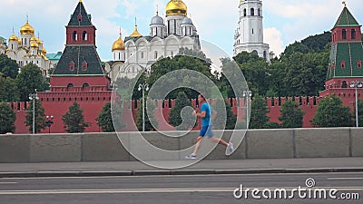 Athletic young man running against Moscow Kremlin Editorial Stock Photo