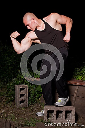 Athletic young man in the slums at night Stock Photo