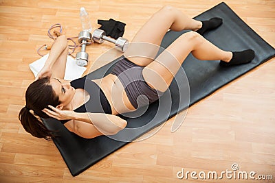 Athletic young woman doing crunches Stock Photo