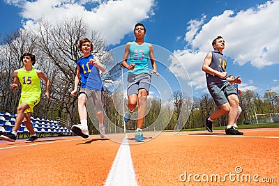 Athletics teenage boys running on the racetrack Stock Photo