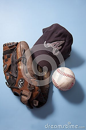 Atlanta Braves MLB ball cap and SPN softball and Rawlings glove Editorial Stock Photo