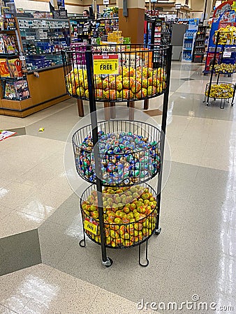 A bin of Reeses and Cadbury chocolate eggs for easter gifts at a Kroger grocery store in Atlanta, GA Editorial Stock Photo