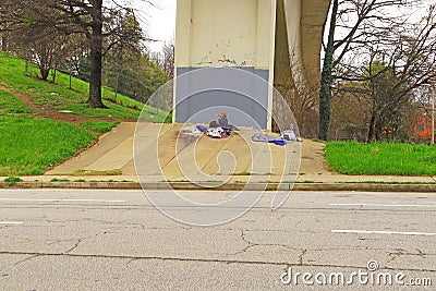 Homeless man camped out under a bridge just outside of downtown Atlanta Georgia Editorial Stock Photo