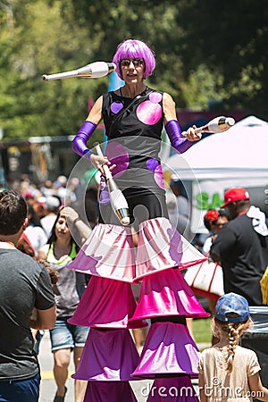 Woman Walking On Stilts Juggles At Atlanta Ice Cream Festival Editorial Stock Photo