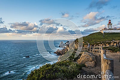 The Atlantic coast north of Cabo da Roca with its lighthouse at sunset Editorial Stock Photo