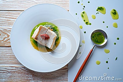 Atlantic hake over dried tomato ratatouille Stock Photo