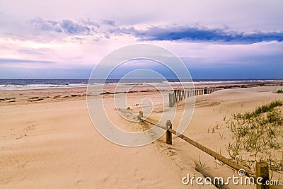 Wooden fence and sandy beach Stock Photo