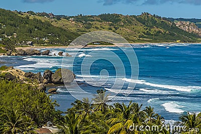 Atlantic roller waves erode the boulders of Bathsheba Beach on the east coast of Barbados Stock Photo