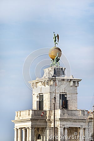 Atlas statues dogana di mare customs house at grand canal in venice italy. 17th century atlases hold globe with weathervane on top Stock Photo