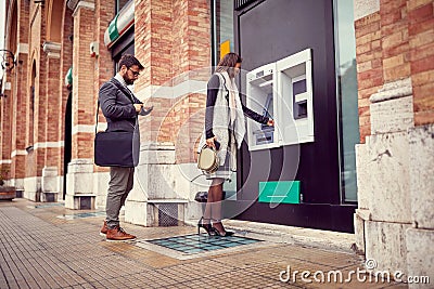 ..ATM cash withdrawal. Girl at the cash machine Stock Photo