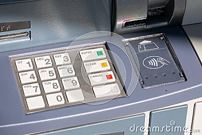 ATM keyboard with plastic buttons for pin code entry with numbers and letters. Card insert slot and contactless near field Editorial Stock Photo