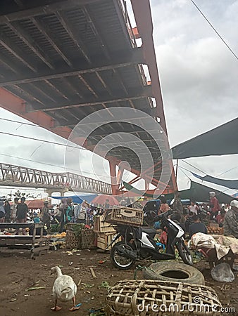 the atmosphere and activities under the Musi 2 Bridge in Palembang, namely the traditional market Editorial Stock Photo