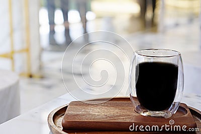 The atmosphere in the shop with a cup of coffee with a blurred background and light. Stock Photo