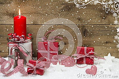 Atmospheric Christmas card with red burning candle and presents Stock Photo