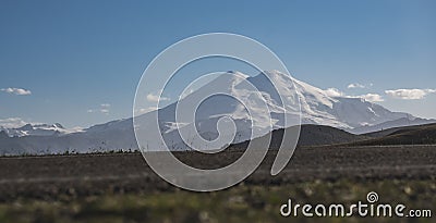 Atmospheric evening panorama of Mount Elbrus with snow and glaciers in the evening in the mountains Stock Photo