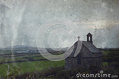 An atmospheric moody, isolated chapel overlooking fields and the countryside. With a vintage, grunge edit Stock Photo