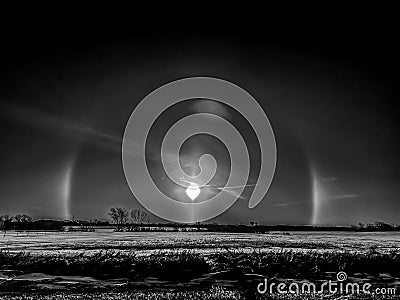 Atmospheric optical phenomenon sun dogs in the morning across a snow field. Stock Photo