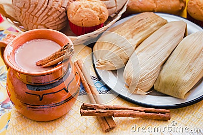 Atole de chocolate, mexican traditional beverage and tamales, Made with cinnamon and chocolate in Mexico Stock Photo