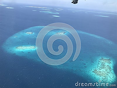 Atolls of the Maldives outside of a plane window Stock Photo