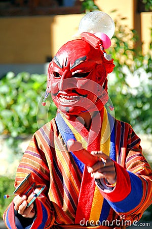 Atsara Joker wearing red traditional Bhutanese dress entertain Stock Photo