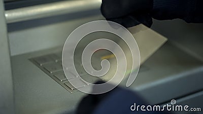 Attacker stealing personal code by removing fingerprints from atm keyboard Stock Photo